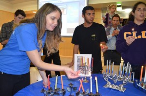 Hanukkah celebrations: Senior Allison Himber lights the menorah at one of the holiday celebrations happening on campus.  Photo by Arianna Cook-  Staff Photographer