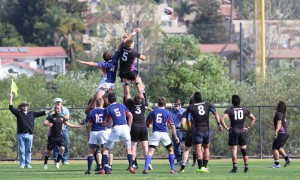 All hands on deck: Sophomore Aaron Bowman is lifted by his teammates during a line out during the Feb. 22 match against Pepperdine University.  Photo by Isabella Del Mese - Staff Photographer
