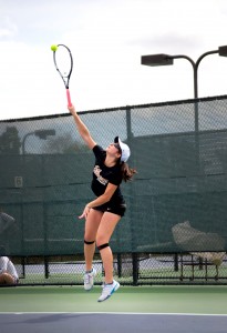 Junior Rebecca Gold serves in her doubles match against Vassar. 