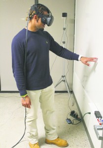 Senior Nathaniel Thompson tests out Emblematic Group’s virtual reality technology. The company recently worked on a prison documentary and virtually placed Thompson in a solitary confinement cell.