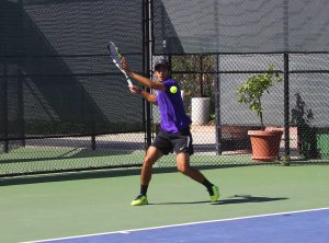 Dara Aryanpour Kashani hits a forehand in his match against Chapman Photo by Adrian Francis- Staff Photographer