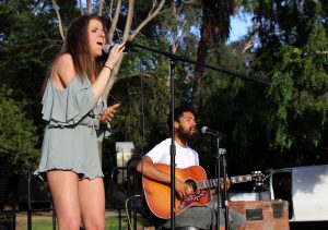 Michaela Kennedy (L) performs an original song called “Just Enough” with guitarist William De Leon (R)
