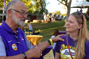 Alumni Karsten Lundring ‘65 (left) and Hayley Wolvseth ‘09 (right) mingle at the homecoming festival. Photo by Aliyah Navarro - Photojournalist