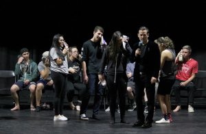 Hello, it’s me: Students who volunteered to be hypnotized at the show Friday night were told that their shoes were phones and were ringing, so they must pick up.  Photo by Rachel Holroyd- Photojournalist