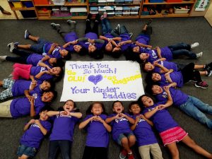 A class of Kinder Buddies poses for a photo in front of a sign thanking their Kingsmen football mentors.  Photo by Catherine Loomis - Ceres Elementary School Teacher 