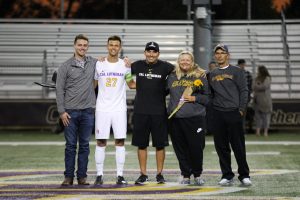 Senior defender Alex Cortez wore his white jersey for the last time as a Kingsmen alongside his family and Head Coach Miguel Ruiz. Photo by Ally Gaskill - Photojournalist