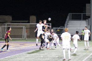 Senior Alex Cortez jumps up for a header against a defender in front of the CMS goal. The Kingsmen fell short to the Staggs on Wednesday 2-0. Photo by Ally Gaskill - Photojournalist