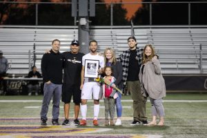 Senior Jared Pischke’s family support him during his last home game as a Kingsmen, alongside head coach Miguel Ruiz. Photo by Ally Gaskill - Photojournalist