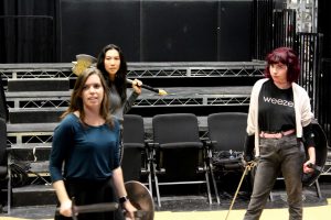 Ready for battle: Cast members of “She Kills Monsters” (left to right) Megan Rackley, Moriah Sittner and Kylie “Red” Patterson rehearse one of the fight scenes set in the fantasy world of Dungeons and Dragons.  Photo by Jovani Garcia-photojournalist 