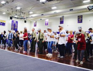 Dodger players, first responders and Borderline families and survivors line dance a routine taught by Victoria Rose Meek.  Photo by Arianna Macaluso - Photo Editor