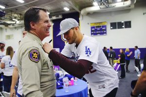 Thousand Oaks Chief of Police Tim Hagel gets his uniform signed by pitcher Adam McCreery.  Photo by Arianna Macaluso - Photo Editor