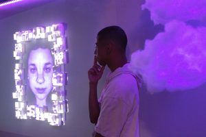 Kiyoshi Taylor (pictured), Annabelle Worrall, and Andrew Tufenkian created “The Purple Room,” part of the multimedia capstone exhibit CLUFest “Colors.”   Photo by Katie May- Photojournalist. 